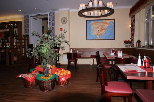 a restaurant with tables and chairs and a map on the wall at Altwernigeröder Apparthotel in Wernigerode