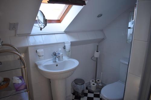 a small bathroom with a sink and a toilet at Clifton Bridge Hotel in York