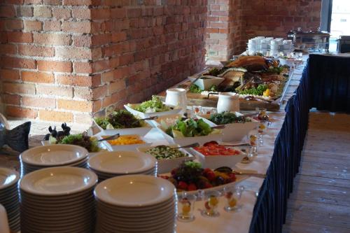 a buffet table with many plates of food at Speicher Barth - Superior-Hotel in Barth