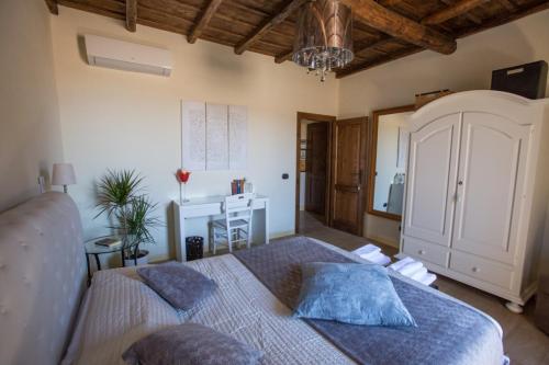 a bedroom with a bed with blue pillows on it at La finestra sul borgo in Bracciano