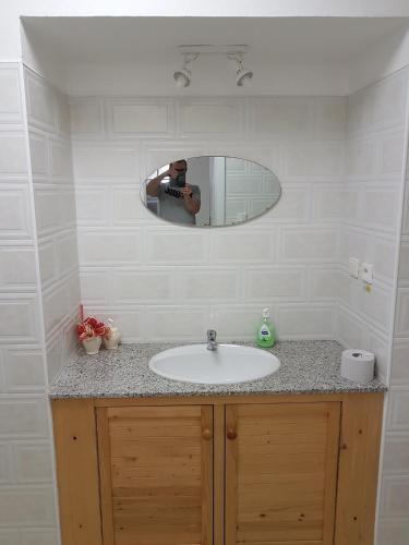 a person taking a picture of a bathroom sink at Apartmany u Dvora in Jihlava