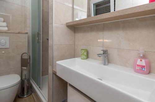 a bathroom with a sink and a toilet at Villa Marija in Trogir