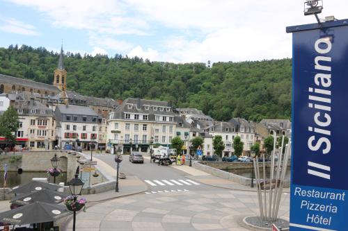 a town with a sign in the middle of a street at Il Siciliano - Duc de Bouillon in Bouillon