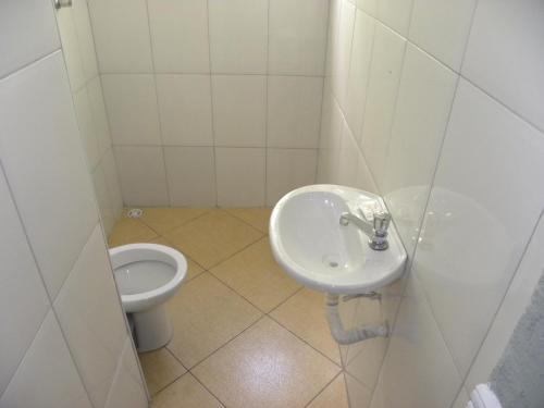 a bathroom with a sink and a toilet at Hotel Tenda Brigadeiro SP in Sao Paulo