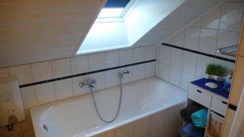a bathroom with a bath tub with a skylight at Ferienwohnung Andrea in Rust