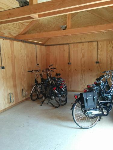 a group of bikes parked in a garage at Hotel Bieze in Borger