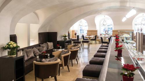 a restaurant with a bunch of chairs and tables at Radisson Blu Hotel Altstadt in Salzburg