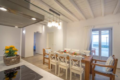a dining room with a table and chairs at Passos Villas in Parasporos