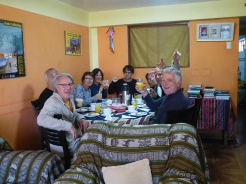 a group of people sitting at a table at Humberto Guest House in Huaraz