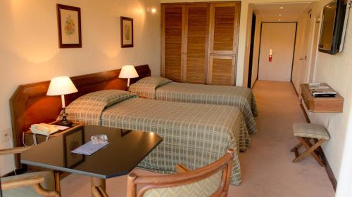 Ένα ή περισσότερα κρεβάτια σε δωμάτιο στο Hotel Horacio Quiroga