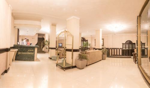 an empty lobby with plants in a building at Prince Hotel in Mar del Plata
