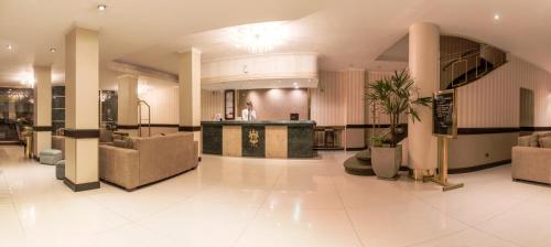 a lobby with chairs and a counter in a building at Prince Hotel in Mar del Plata