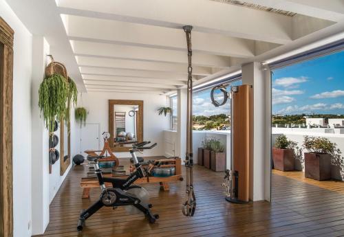 a gym with treadmills and exercise bikes at Hotel Es Marès in Sant Francesc Xavier