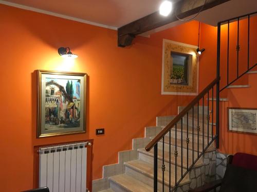 a staircase in a house with orange walls at B&B Vista su Roma in Marco Simone