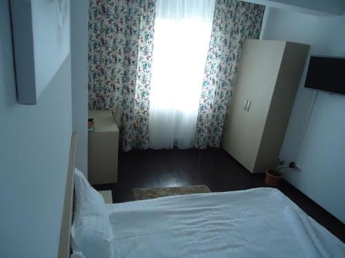 Ένα ή περισσότερα κρεβάτια σε δωμάτιο στο Hotel Nova Residence