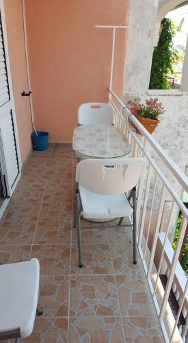 a patio with two chairs and a table on a balcony at Apartments Alissa in Hvar
