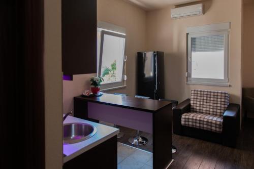 a small kitchen with a sink and a refrigerator at Apartments Dujmović in Međugorje