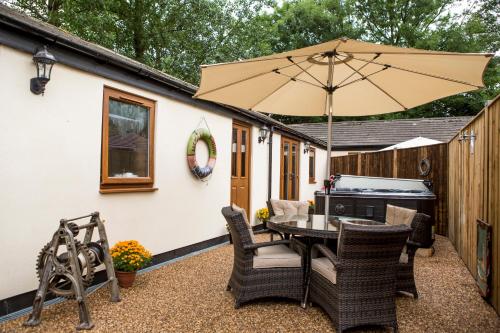 a patio with a table and an umbrella at South Causey Inn in Stanley