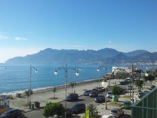 a parking lot next to the ocean with cars parked at Leucosia Bed & Breakfast in Salerno