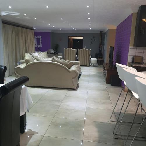 a living room with a couch and a table at Dinaledi House in Bela-Bela