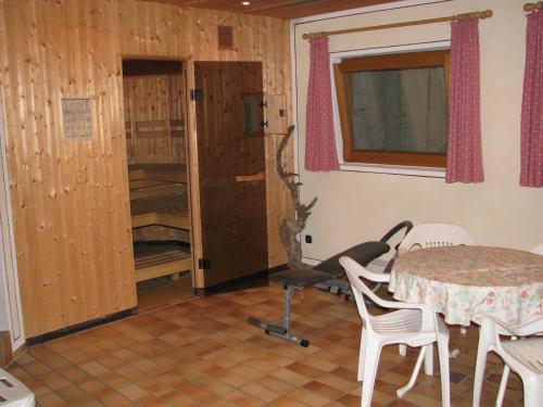 a room with a table and chairs and a table and a window at Ferienparadies Spielmannsau in Oberstdorf