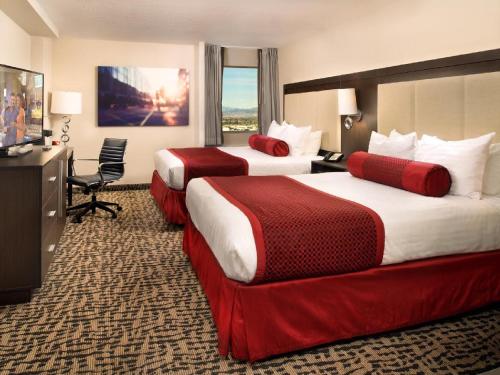 a hotel room with two beds and a television at The STRAT Hotel, Casino & Tower in Las Vegas