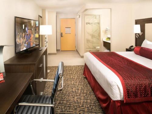 a hotel room with a bed and a television at The STRAT Hotel, Casino & Tower in Las Vegas