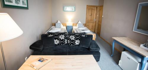 a small room with two beds and a table at Anielski Zakątek Polańczyk in Polańczyk