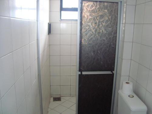 a small bathroom with a shower with a toilet at Pousada Vianna's in Fortaleza