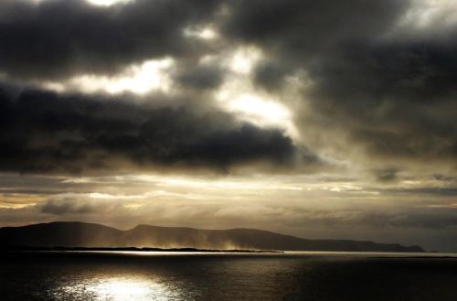 a cloudy sky over a body of water at Harbour front apartments in Burtonport