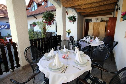 a restaurant with tables and chairs with napkins on them at Restaurant penzion u Buchlovskeho zamku in Buchlovice