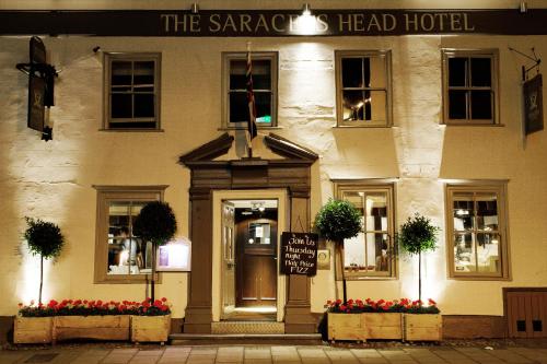 a hotel with a sign on the front of a building at The Saracens Head Hotel - The Coaching Inn Group in Great Dunmow