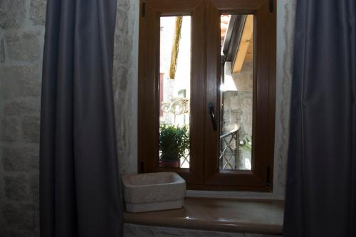 a window in a room with a curtain at Villa Kudelik - Stone Story in Trogir