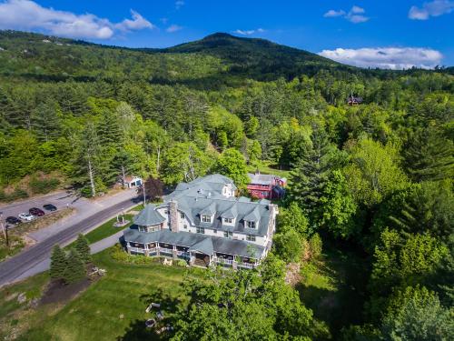 an aerial view of a large house in the mountains at The Inn at Thorn Hill in Jackson