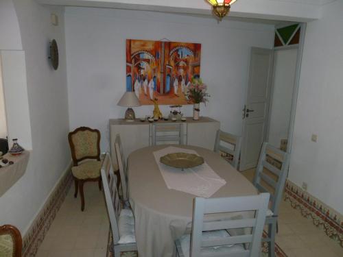 a dining room with a table and chairs at Dar Chebba in Oualidia