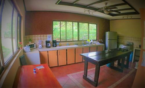 a kitchen with a table in the middle of it at Casa Karen in Tamarindo
