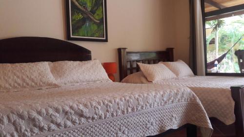 سرير أو أسرّة في غرفة في Casa Karen