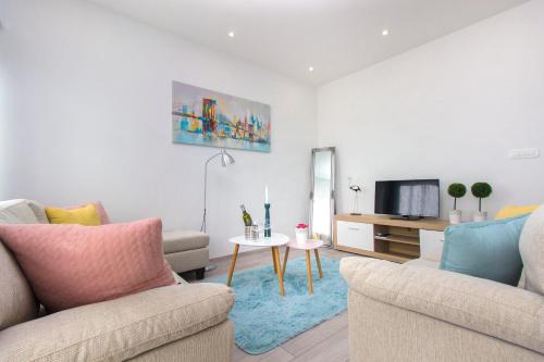 a living room with two couches and a tv at Luxury Apartment Ante in Kaštela