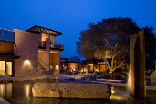 a building with a fountain in front of it at night at Bardessono Hotel and Spa in Yountville