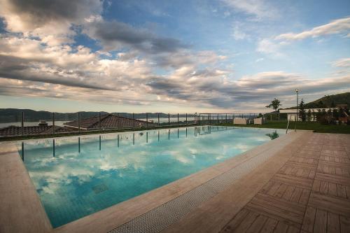 a large swimming pool on a building with a cloudy sky at Pasha Villas in Sapanca