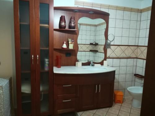 a bathroom with a sink and a mirror at Trilocale La Corte in Montaquila