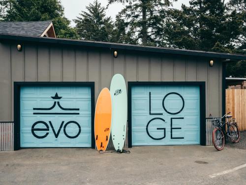 two garage doors with two surfboards painted on them at LOGE Westport in Westport