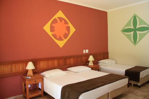 Cama ou camas em um quarto em Hotel Pousada Brilho do Sol