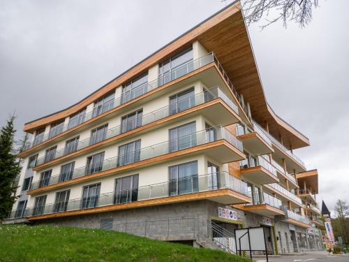 a building with balconies on the side of it at Apartmán Cyril A 104 in Smokovce