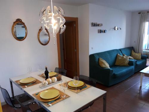 a living room with a table and a blue couch at Playa Viginia in Málaga