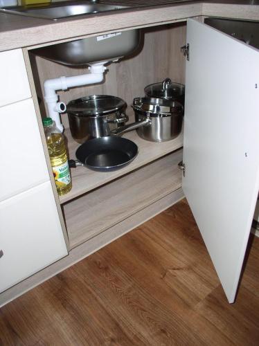 a kitchen with pots and pans on a shelf at Apartmán Cyril A 104 in Smokovce