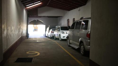 a parking lot with cars parked in a garage at Hotel Cacique Adiact in León
