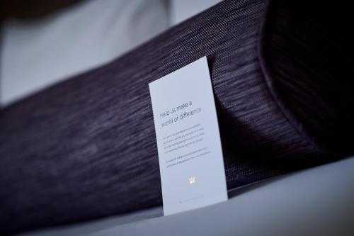 a piece of wood with a white card on it at Warwick Denver in Denver