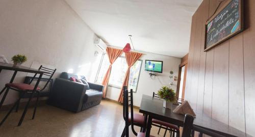 a living room with a couch and a table at Destino San Juan Hostel in San Juan