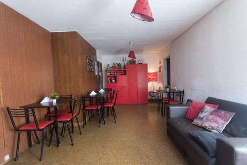 a living room with a couch and a red refrigerator at Destino San Juan Hostel in San Juan